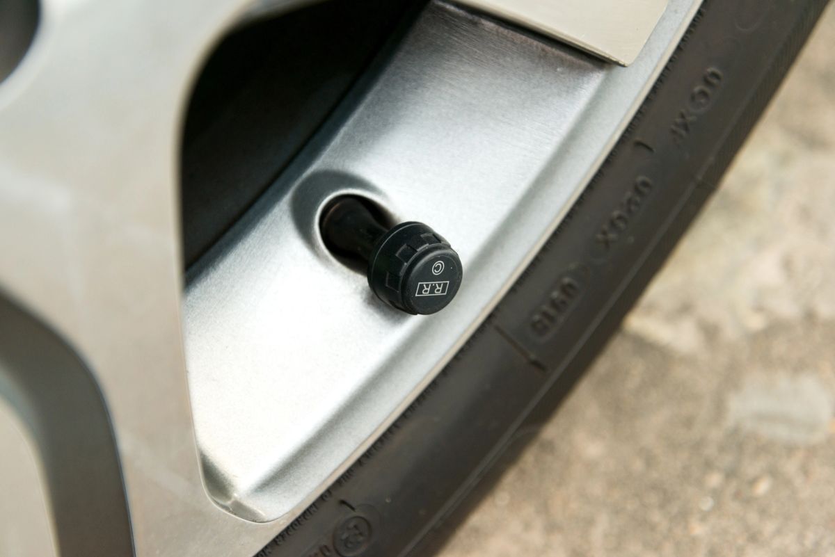 A tire pressure monitoring sensor on a vehicle wheel.